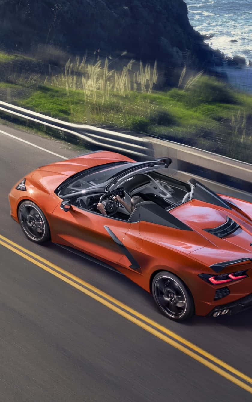 Orange Corvette C8 Convertible Coastal Road Background