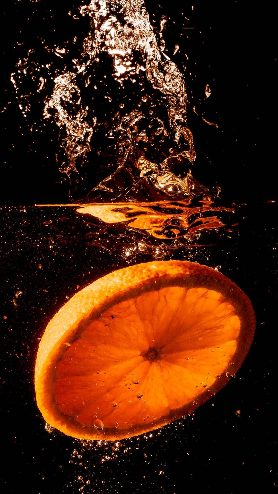 Orange Fruit Dropped In Water Background