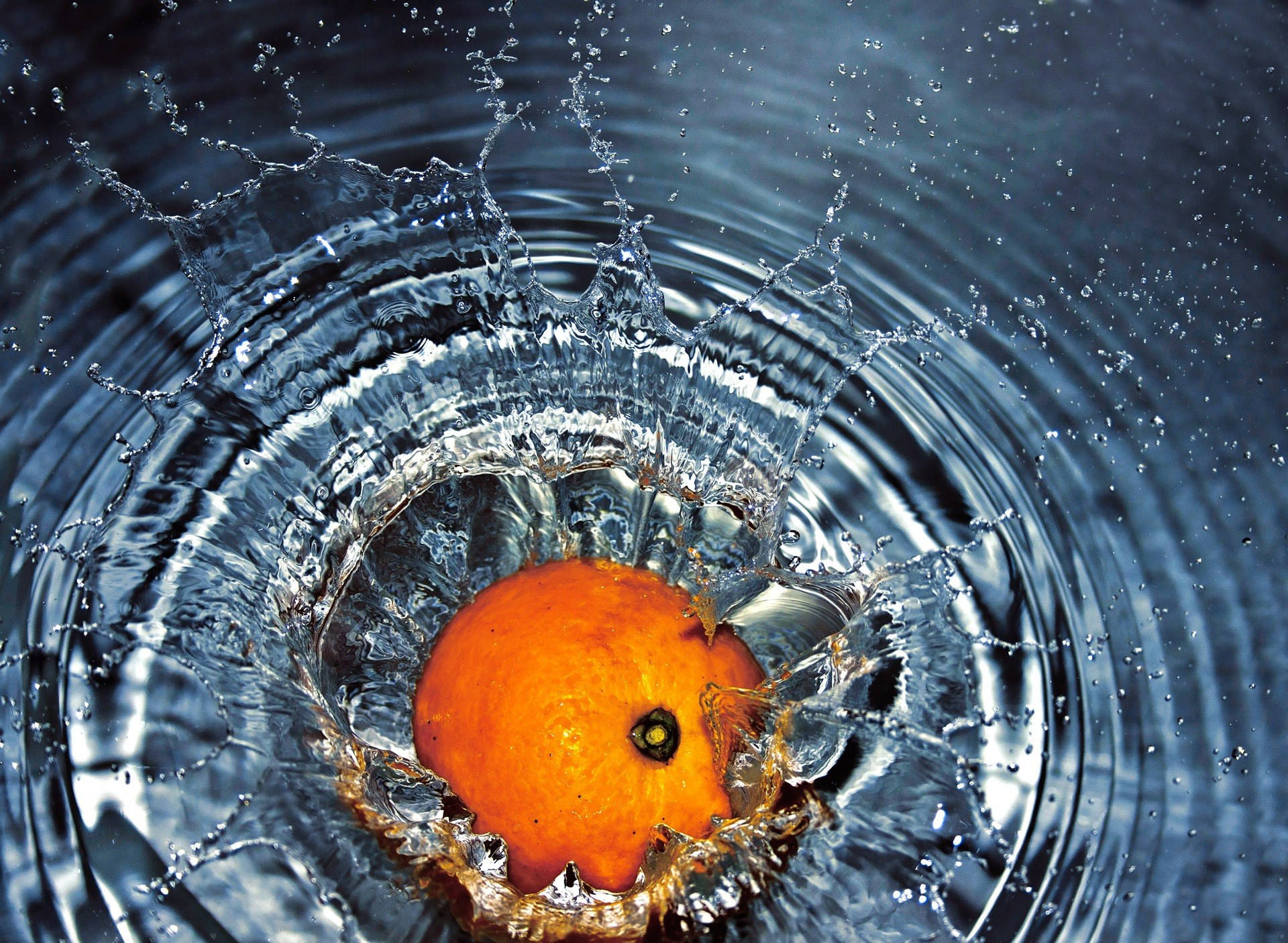 Orange Fruit Falling In The Water