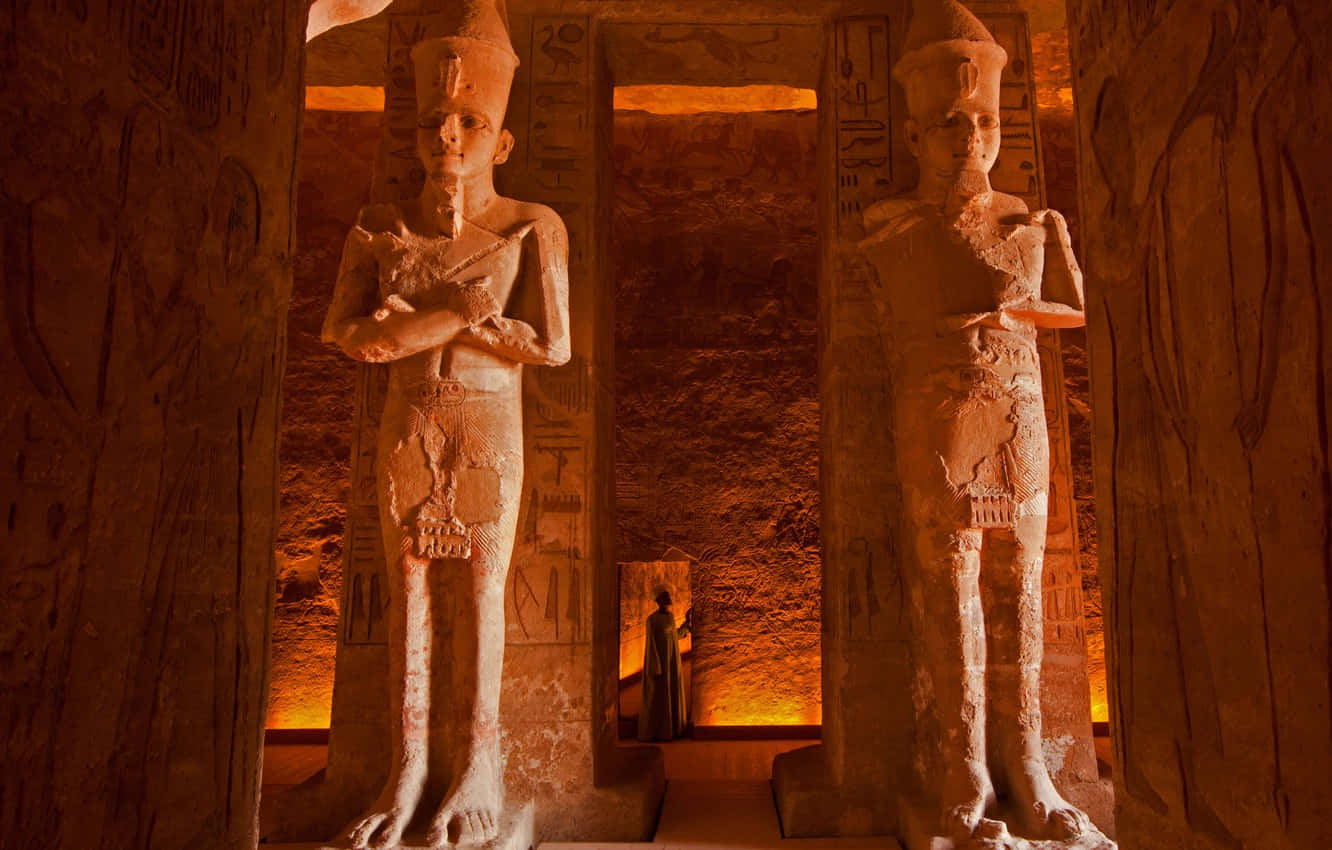 Orange Light Within The Statues Inside The Egyptian Museum Background