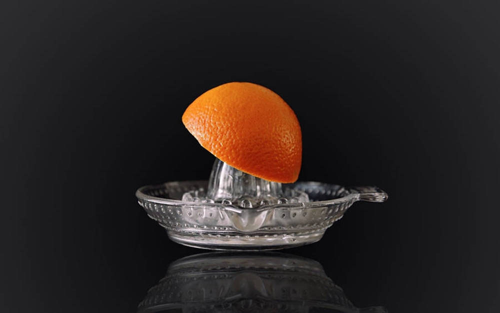 Orange On A Juicer Reamer Background