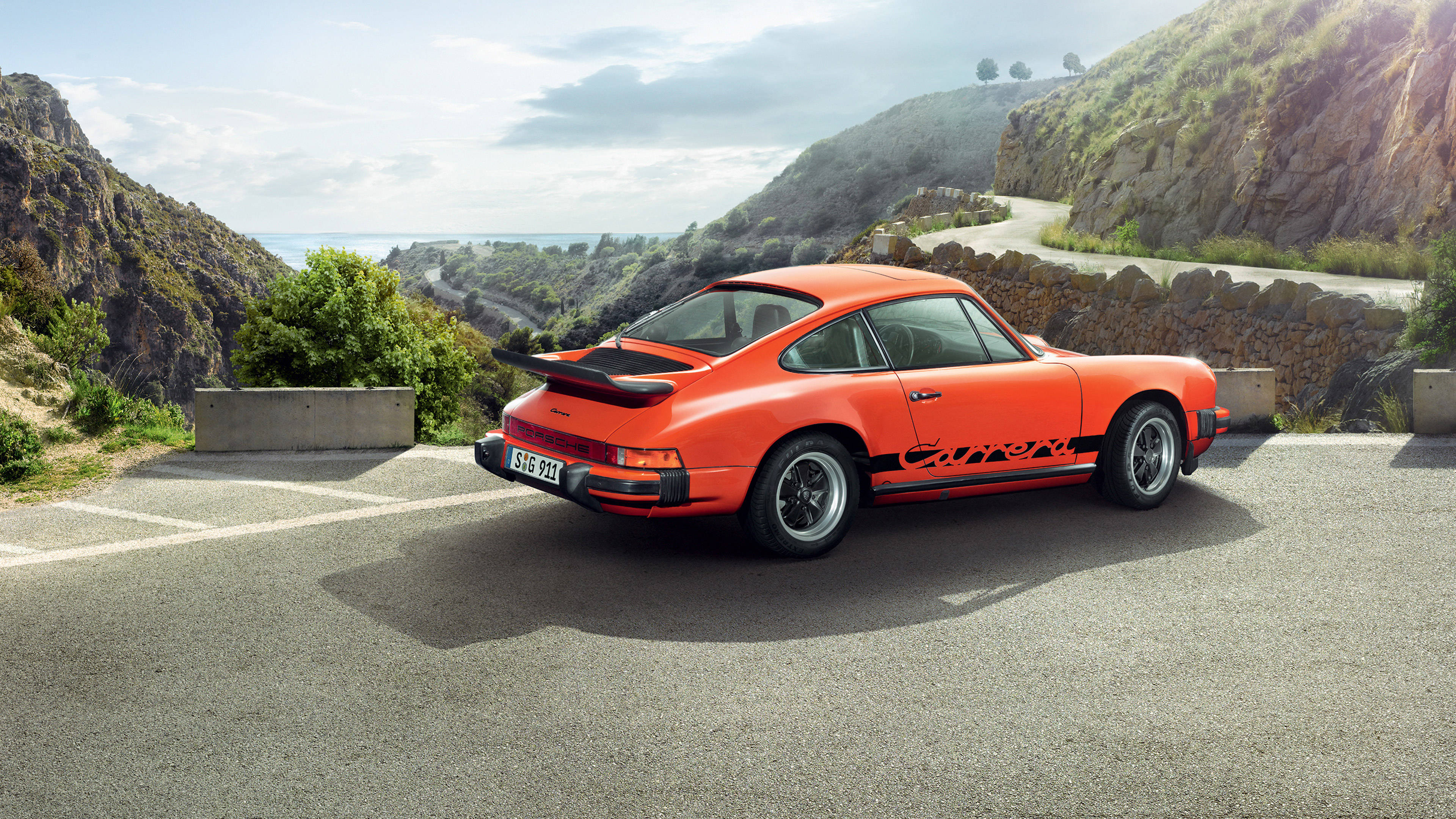 Orange Porsche 911 On Mountain Road Background