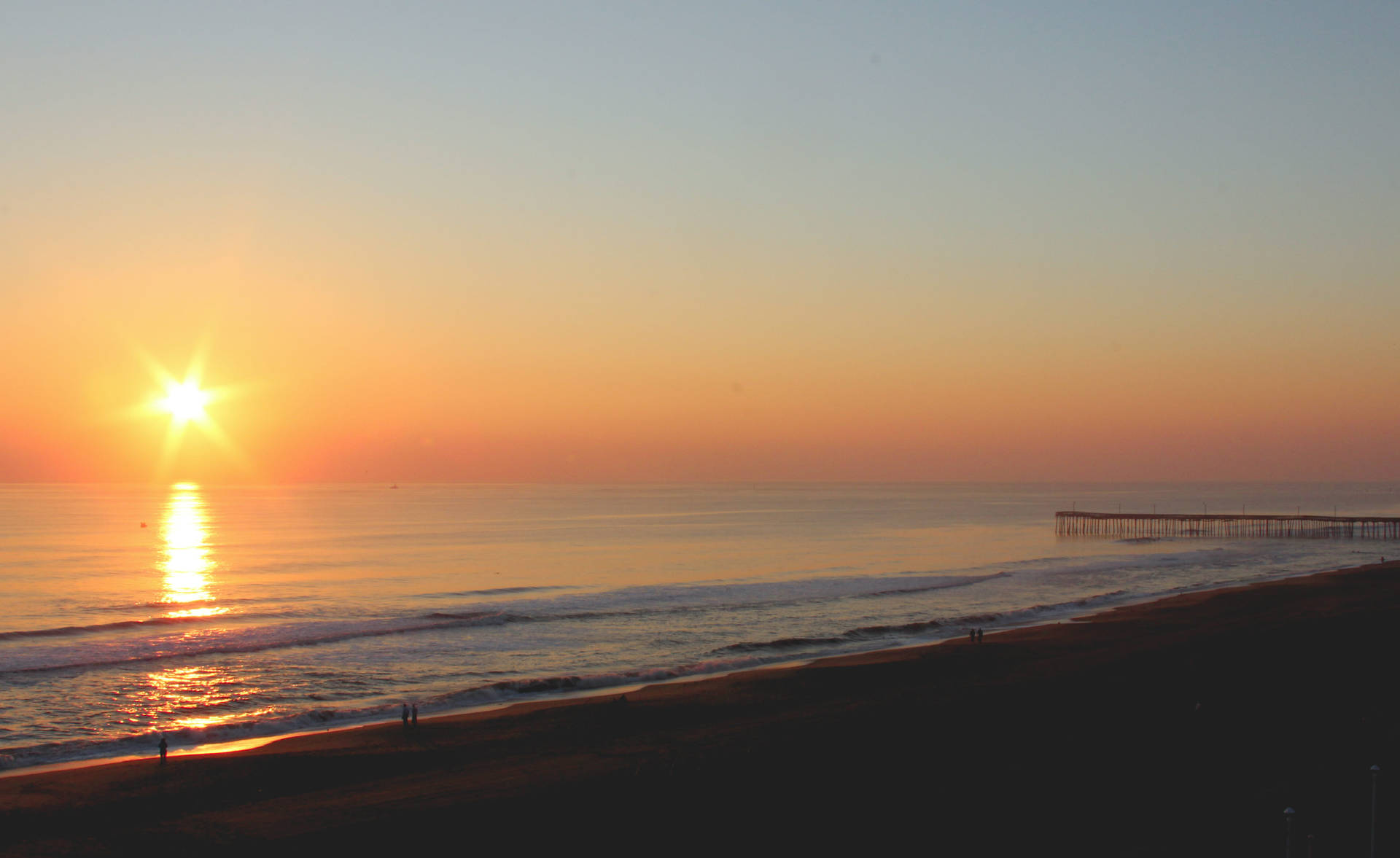 Orange Sun Rising Above Virginia Beach Background