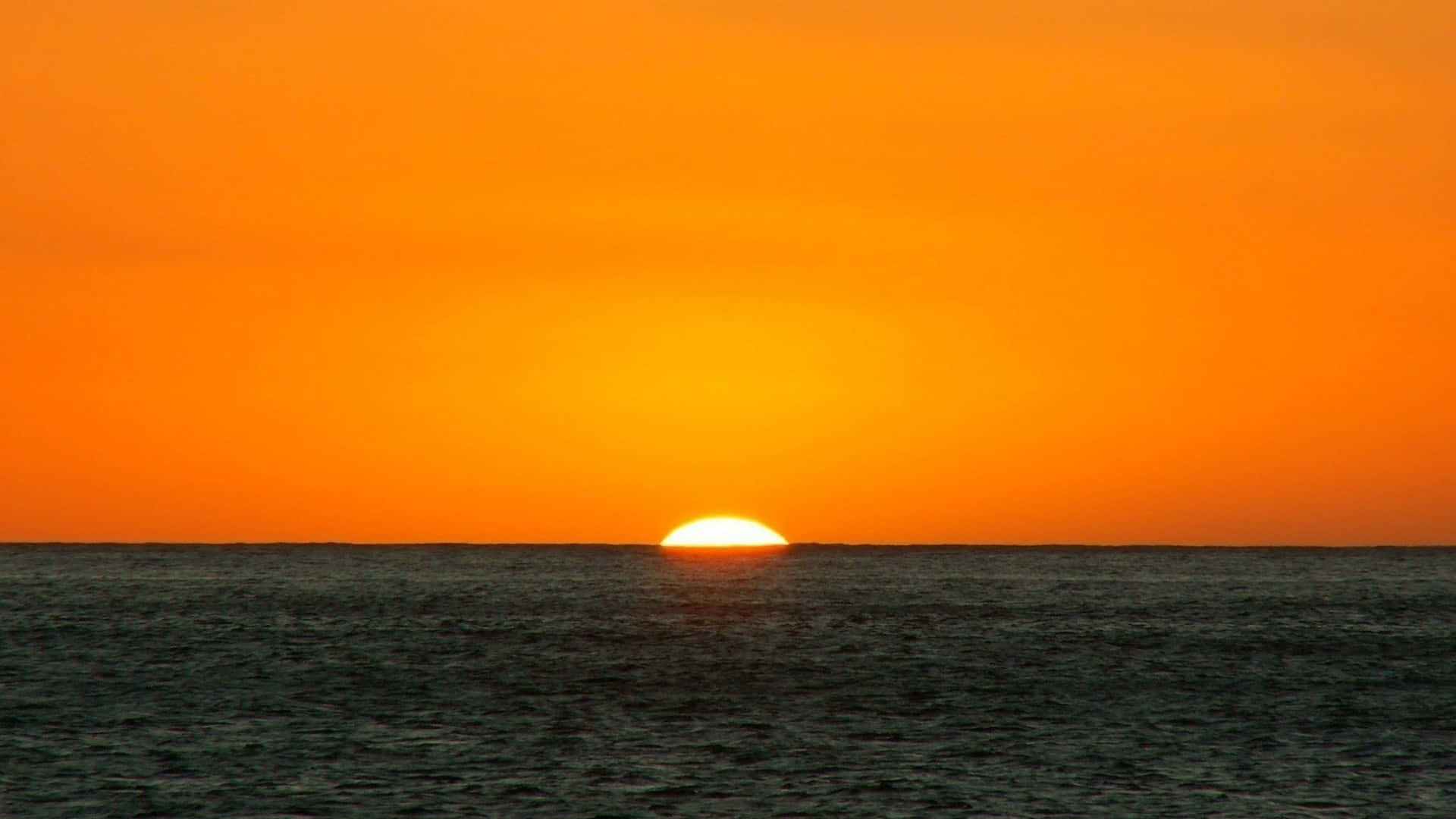 Orange Sunset And Blue Ocean Background