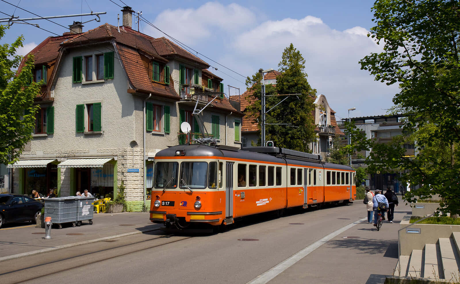 Orange Tram In Urban Street Background