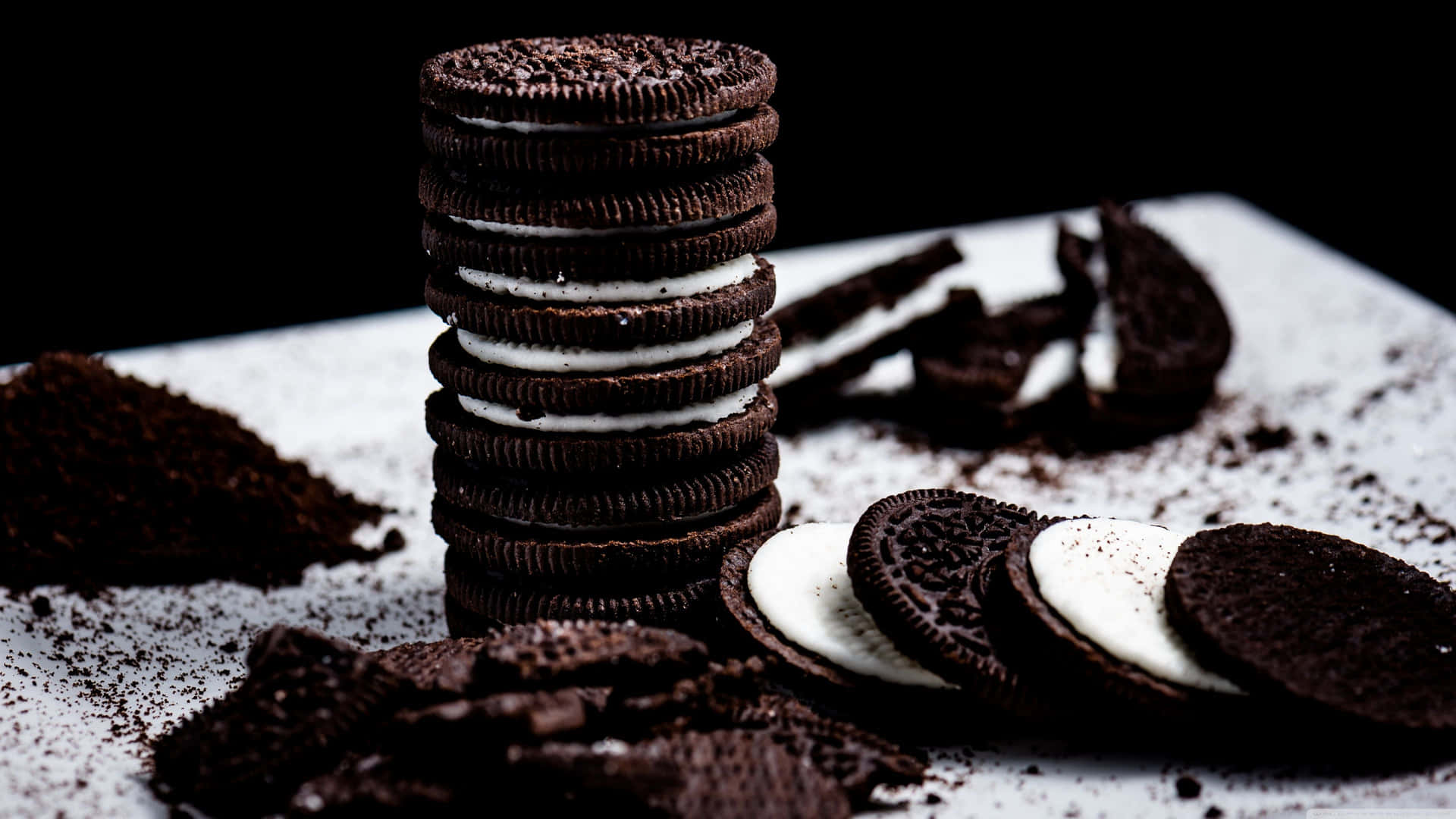 Oreo Cookies On A White Plate With A Pile Of Crumbs Background