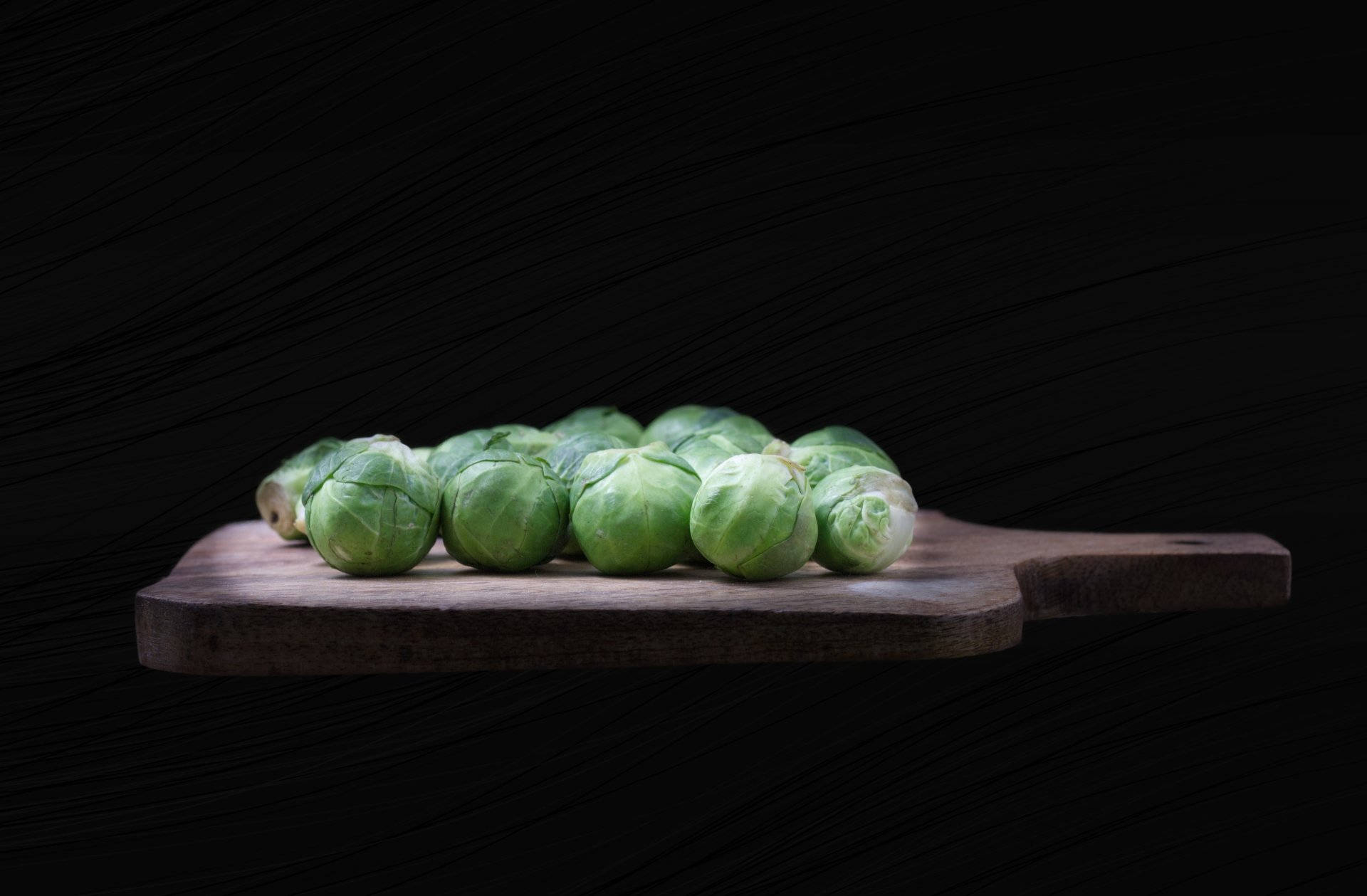 Organic Brussels Sprouts On Cutting Board Background