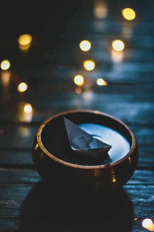 Origami Boat Floating In Bowl