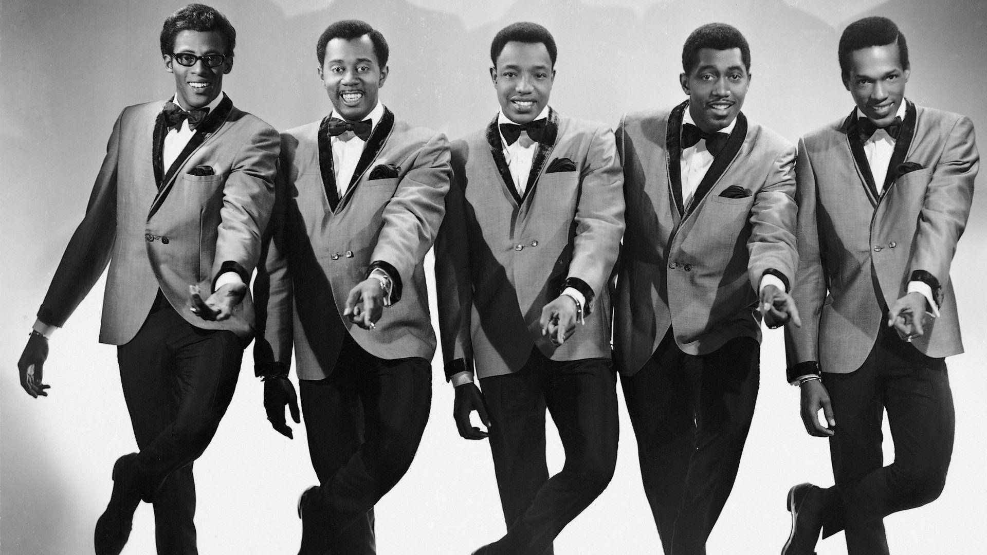 Original Members Of The Temptations Ensemble In Classic Black And White Photograph Background