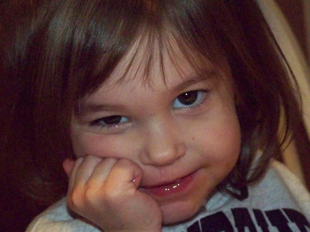 Ornery Little Girl Holding Face Background