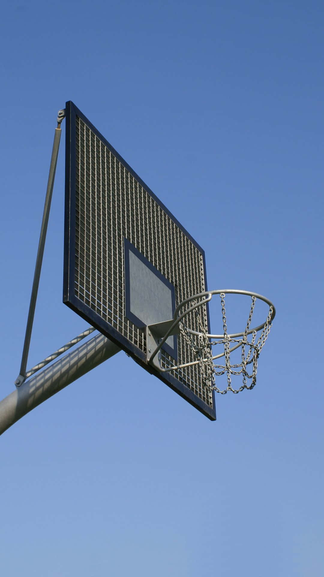 Outdoor Basketball Hoop Against Blue Sky Background