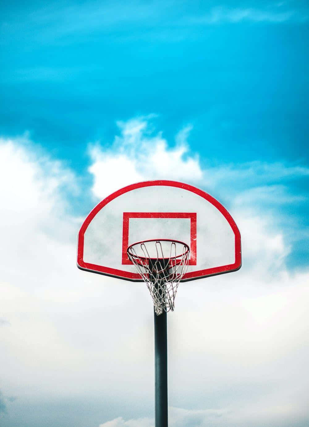 Outdoor Basketball Hoop Against Blue Sky