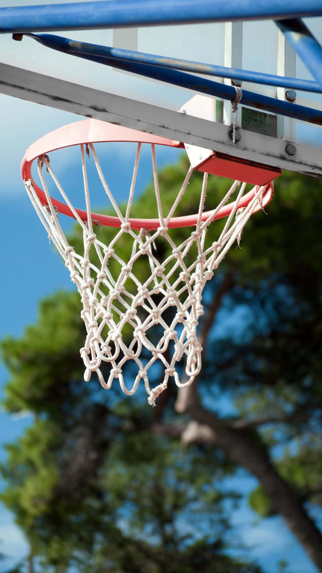 Outdoor Basketball Hoop Against Blue Sky Background
