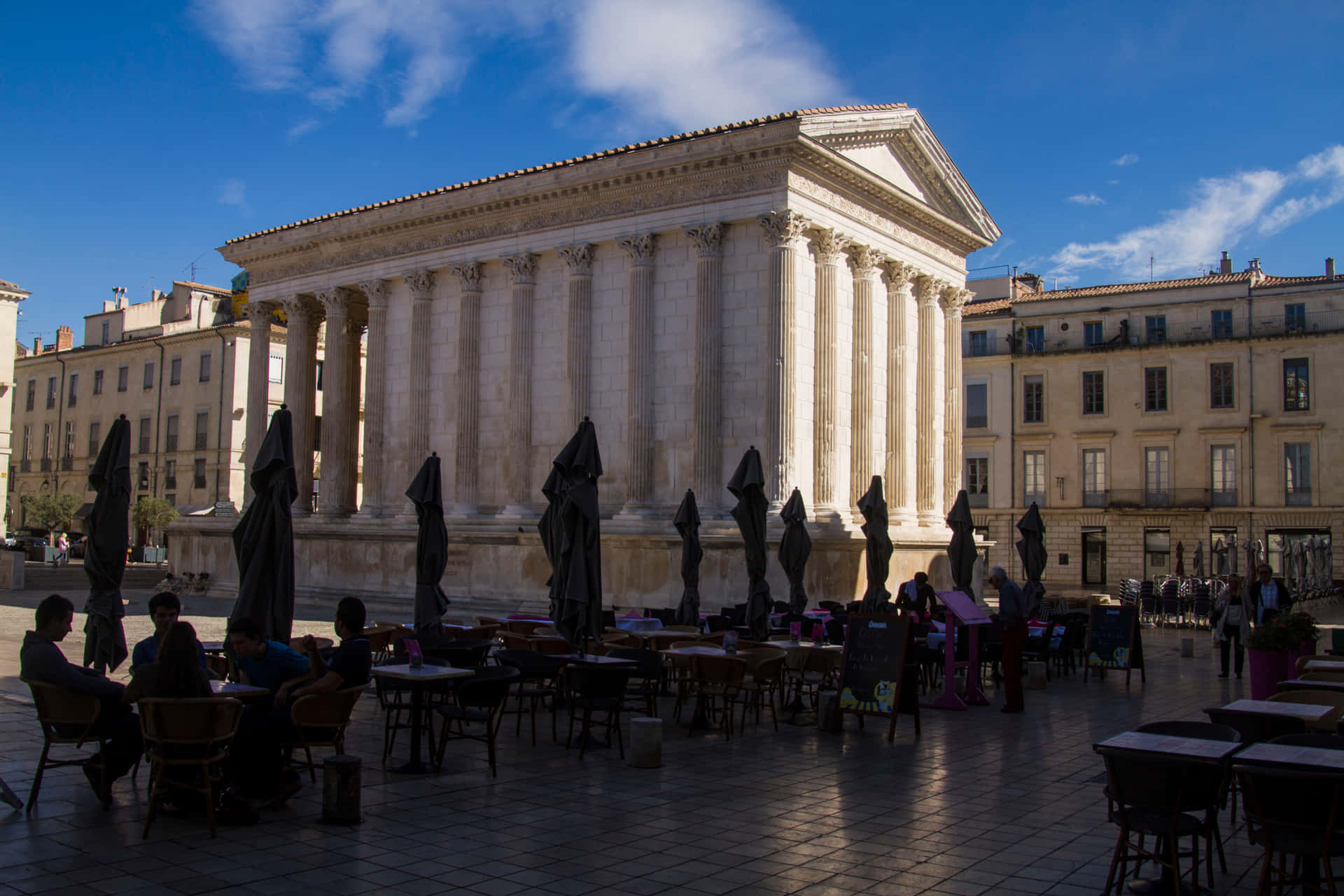 Outdoor Tables Behind Maison Carrée Background