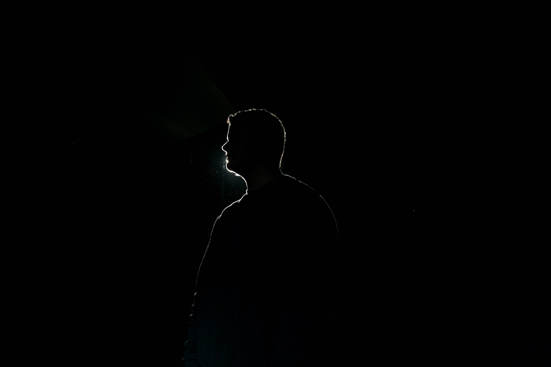 Outline Of A Man Profile On Black Backdrop