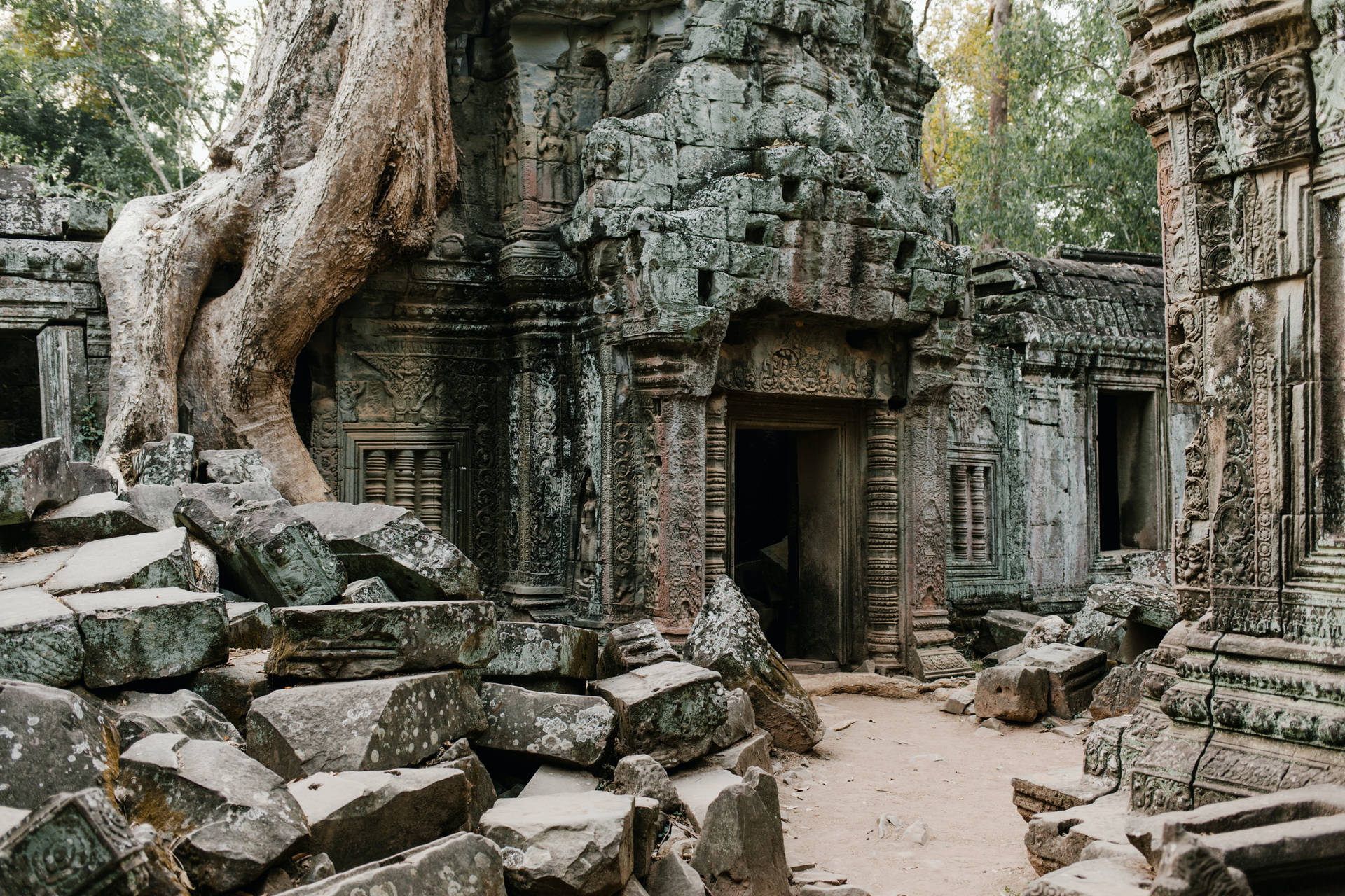 Overgrown Ruins Of Angkor Wat With Fallen Bricks Background