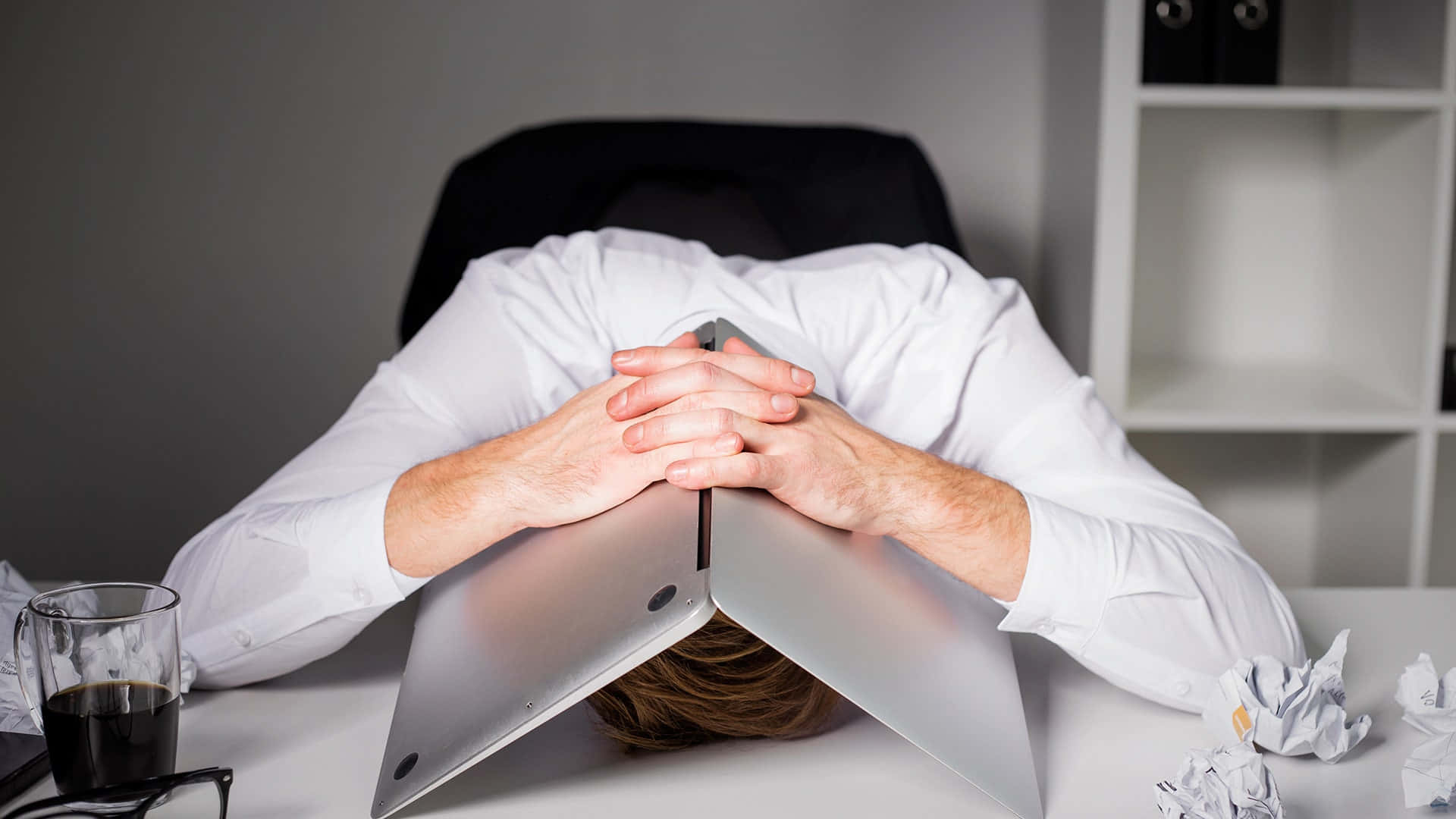 Overwhelmed Man Concealing Himself Under Laptop Background