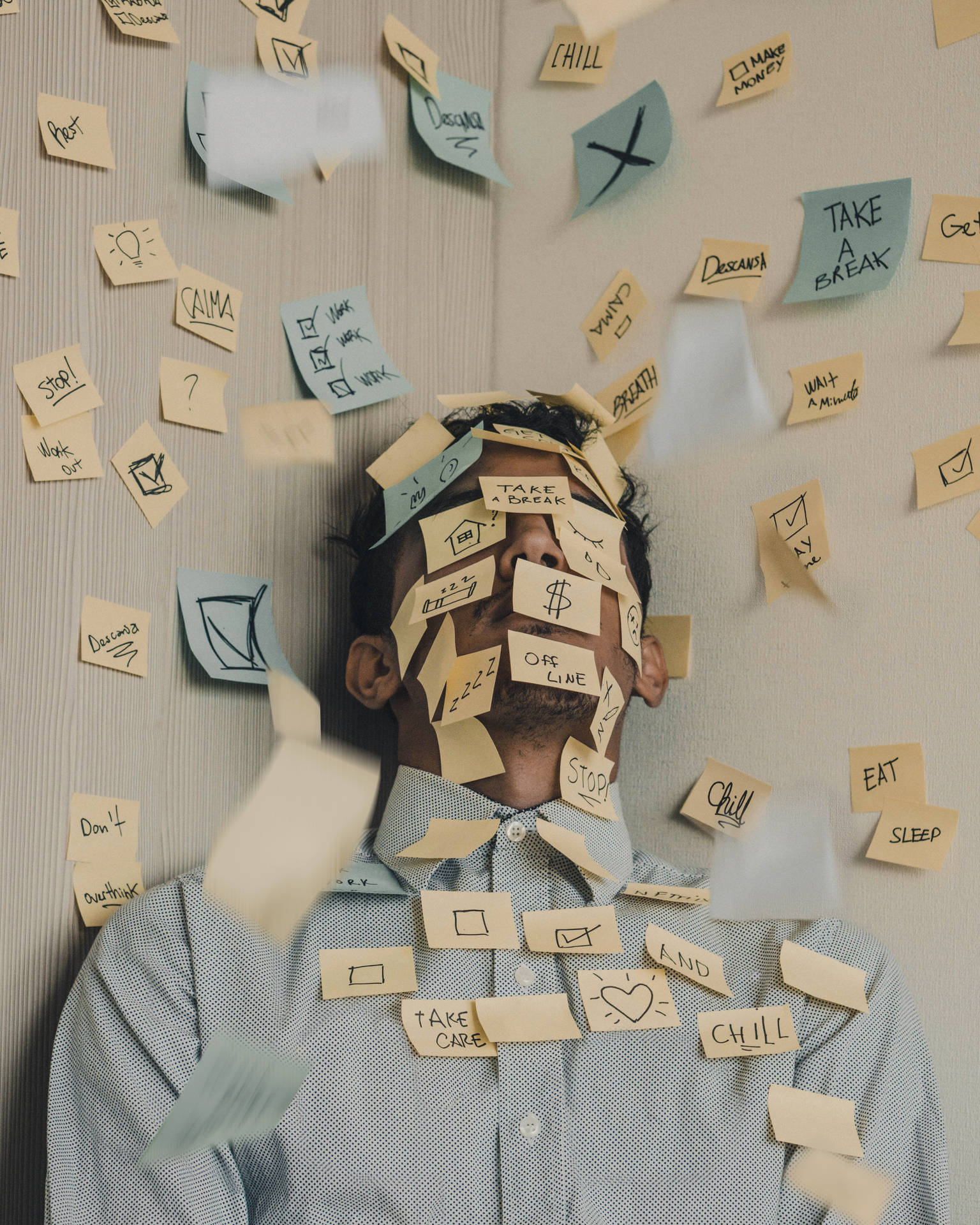 Overwhelmed Man Engulfed In Post-it Tasks Background