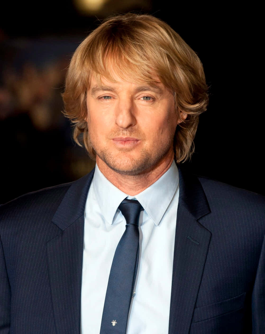 Owen Wilson Smilingly Posing For A Closeup Background
