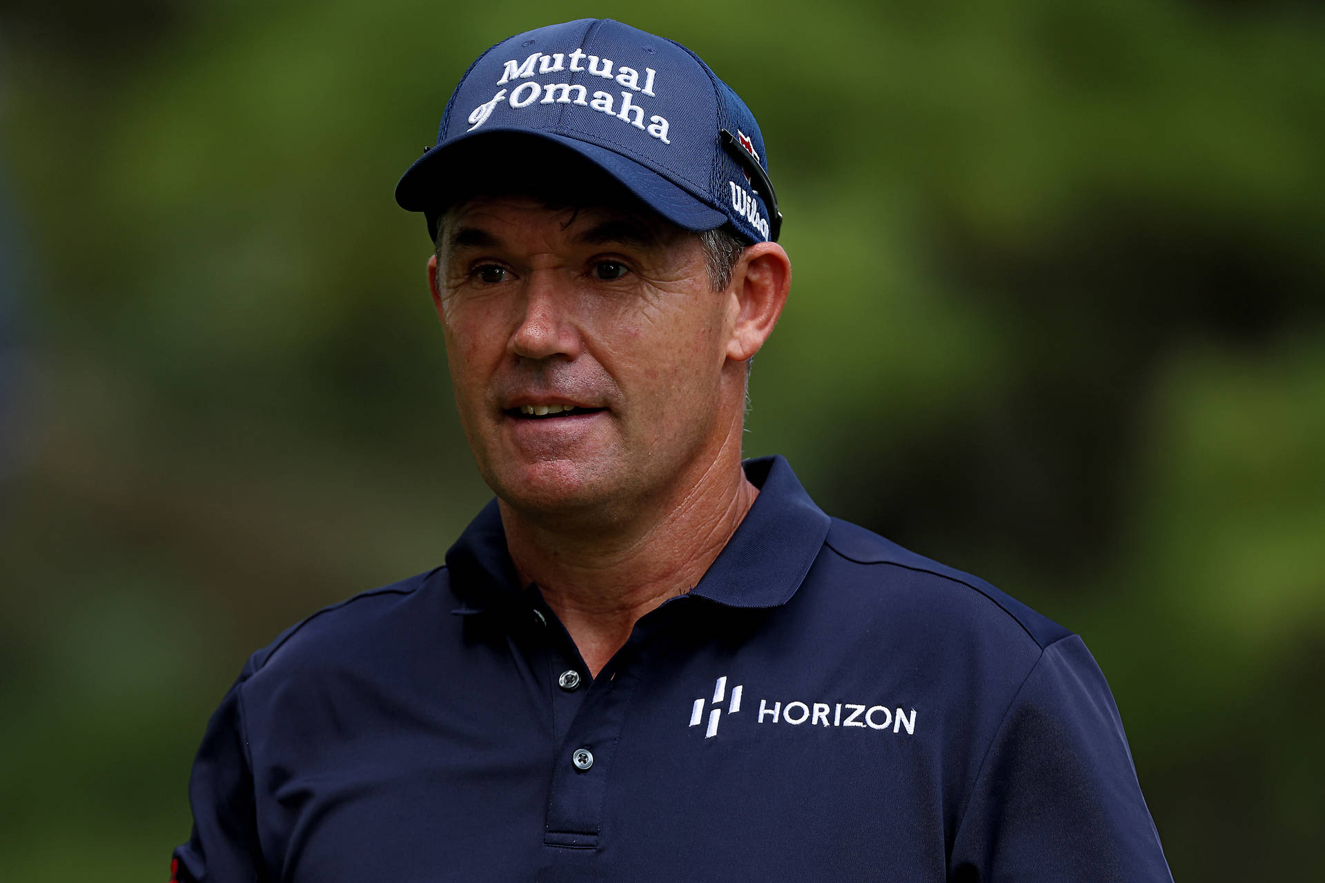 Padraig Harrington, Golf Professional In A Blue Cap And Uniform Background