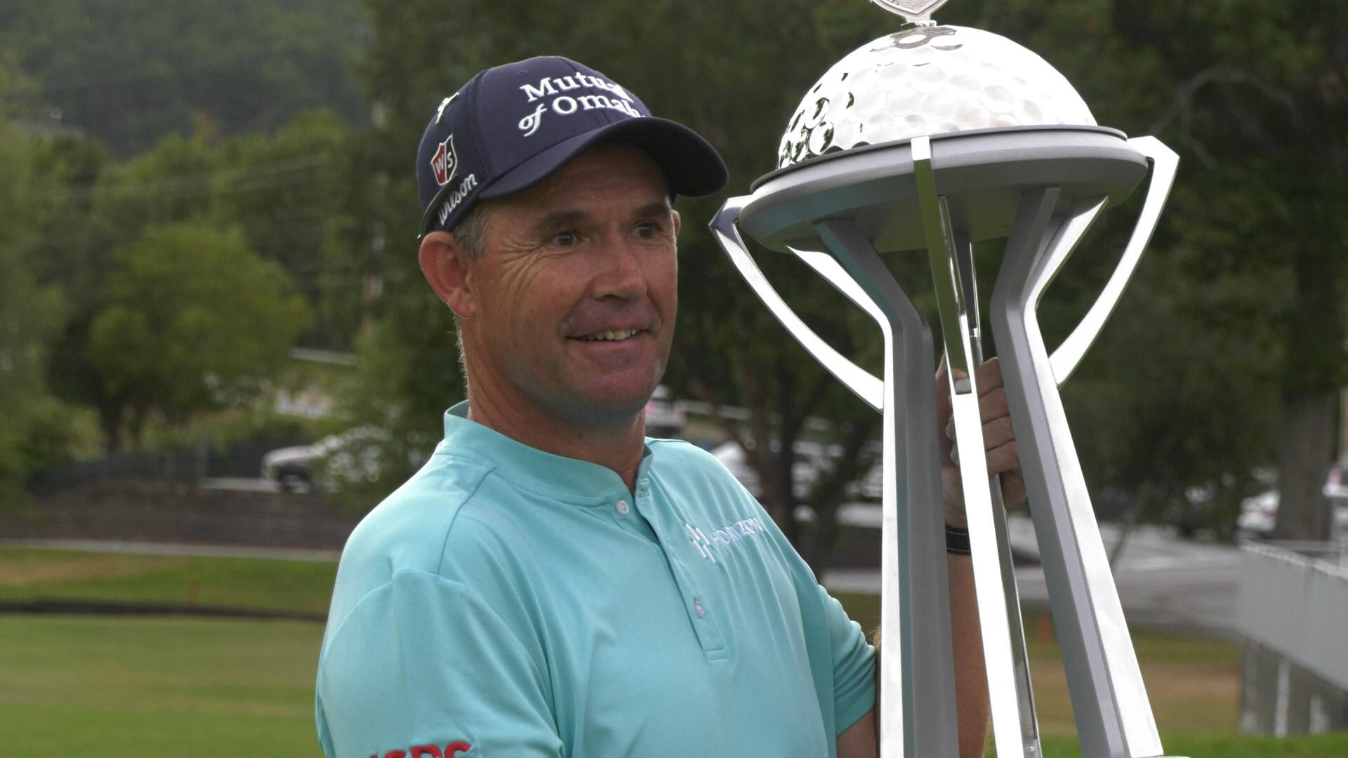 Padraig Harrington Triumphantly Holds His Trophy Background