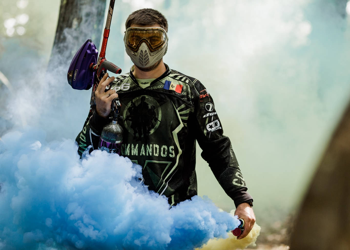 Paintball Player With Blue Smoke Background