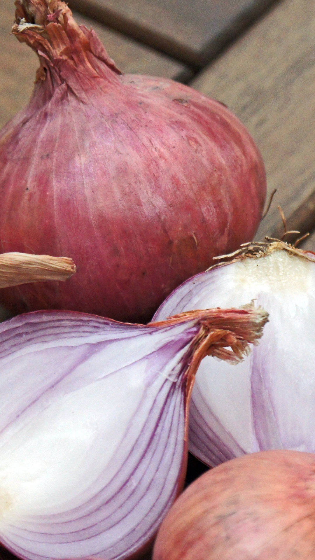 Pale Red Onions On Wooden Planks Background