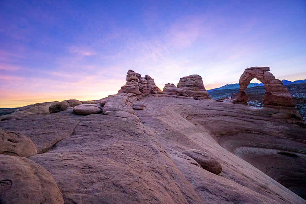 Pale Rocks Of Delicate Arch Background