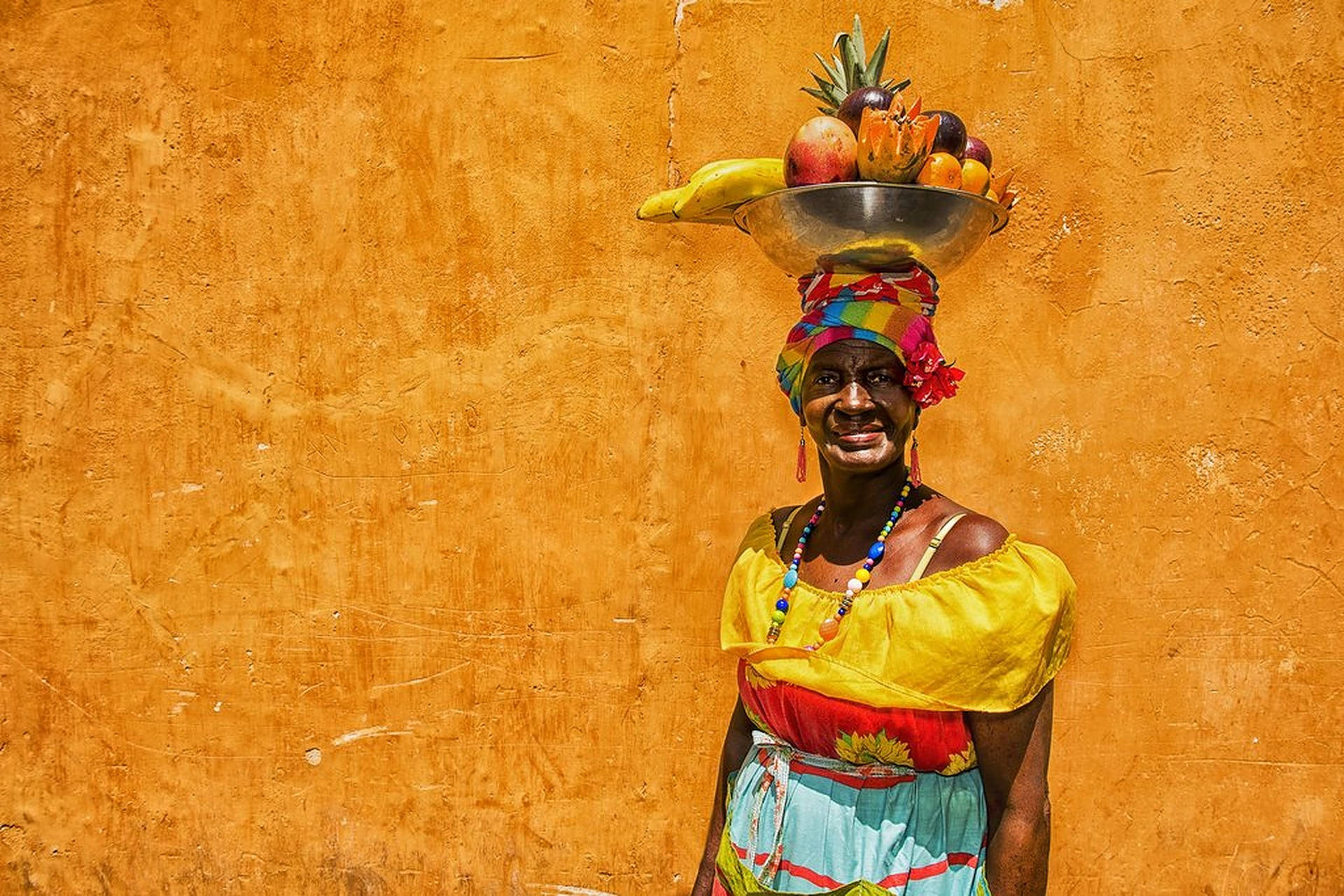 Palenquera Lady Carrying Fruit Basket In Colombia Background