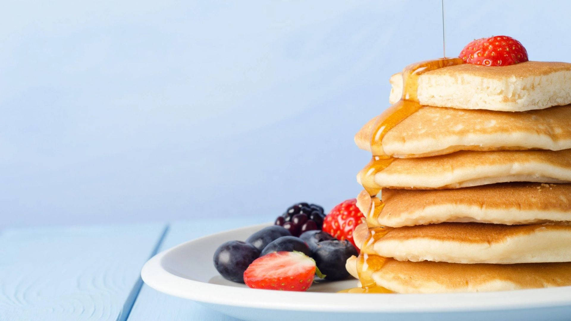 Pancakes And Berries On The Plate Background