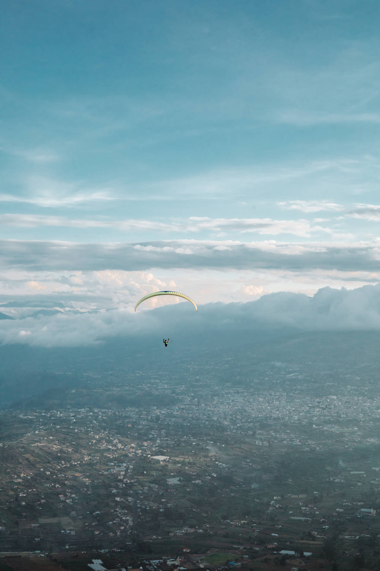Paragliding Above Banos City Background