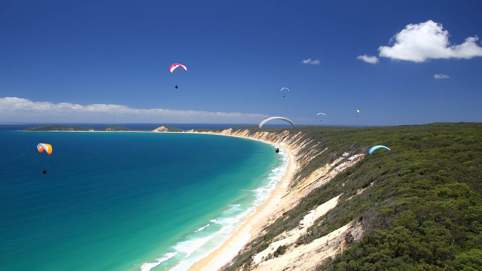 Paragliding Above Colossal Slanted Cliff Background