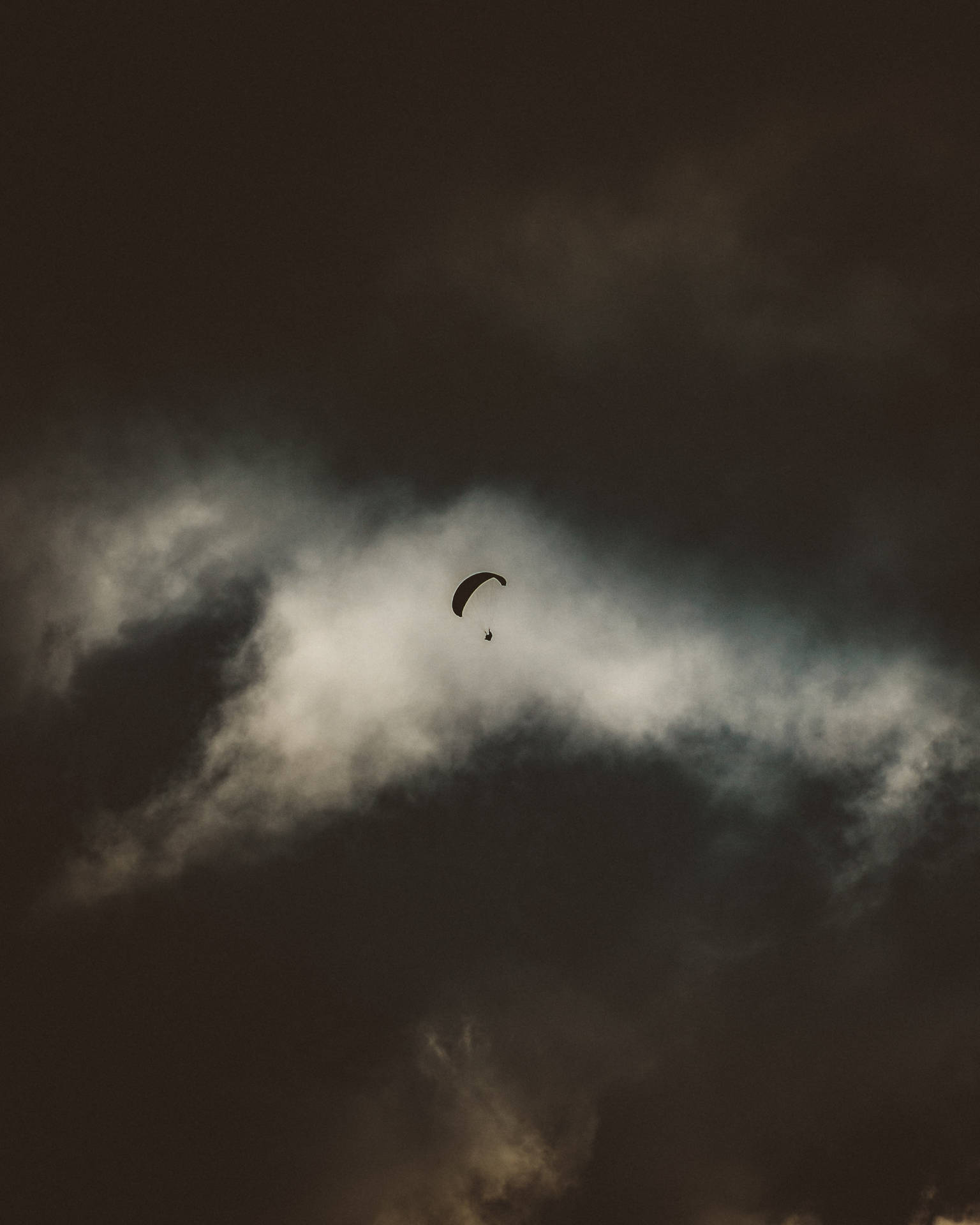 Paragliding Against Dark Sky Background