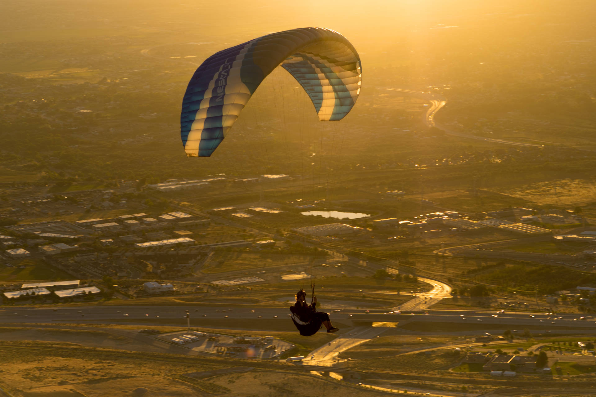 Paragliding Against Gleaming Sunset Background