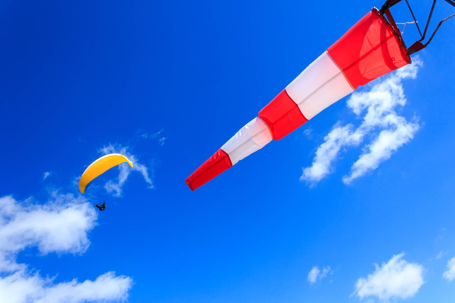 Paragliding Near Wind Indicator Flag Background