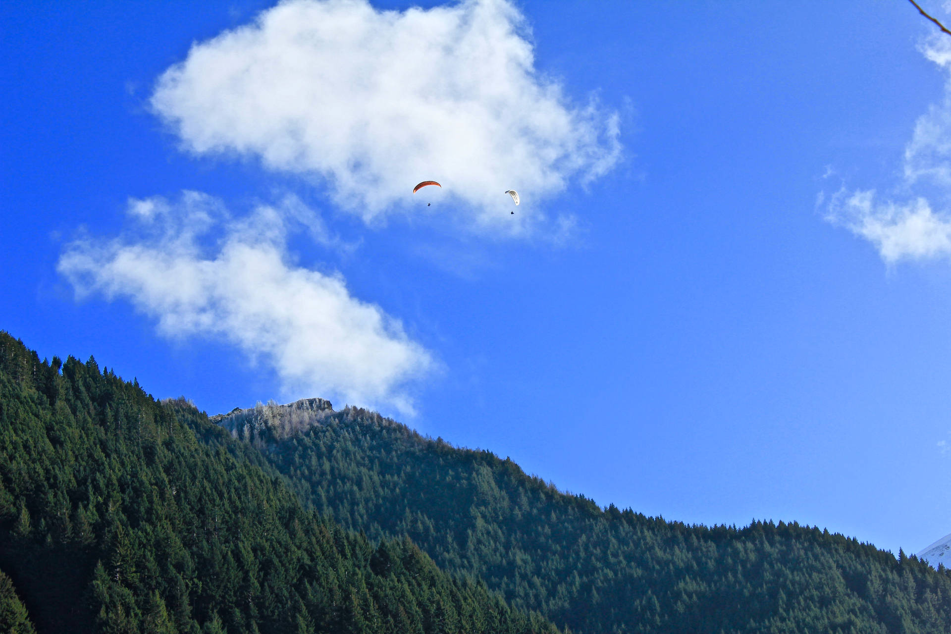 Paragliding Over Steep Mountains Background