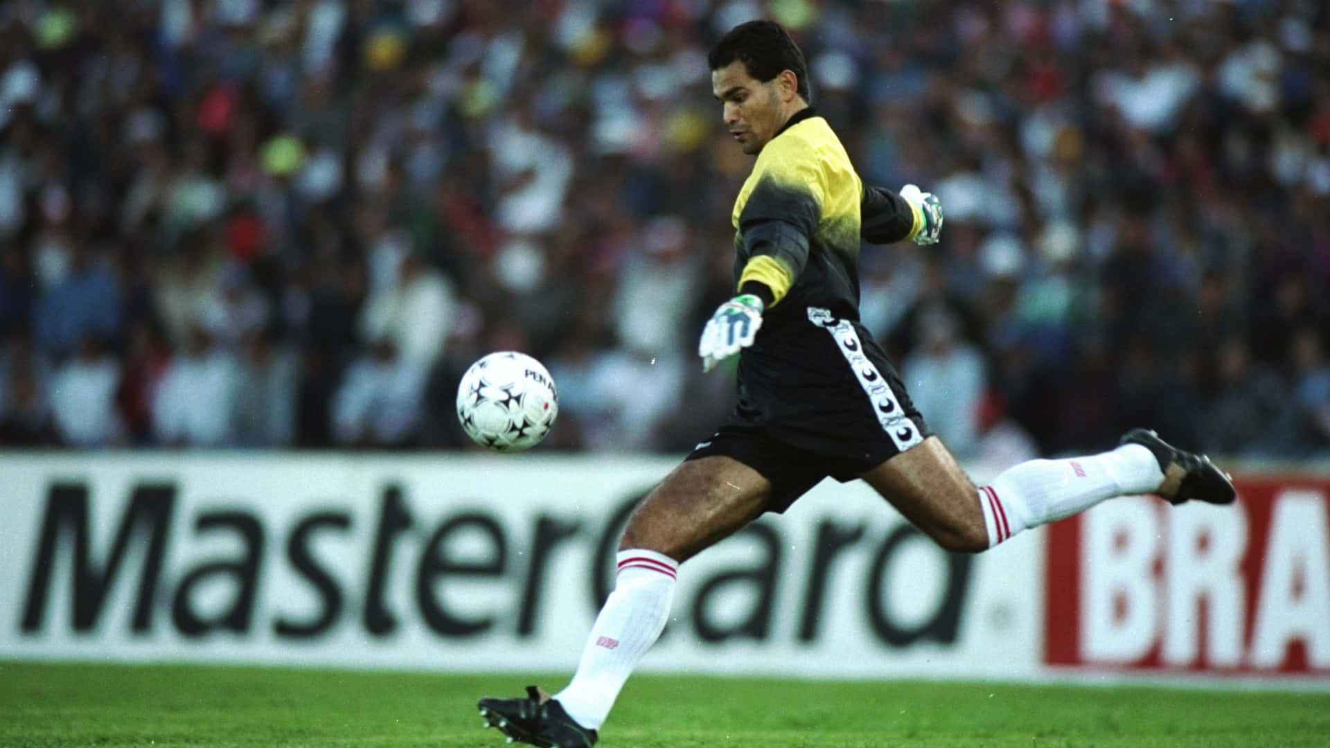 Paraguayan Football Team Goalkeeper Jose Luis Chilavert Kicking A Ball Background