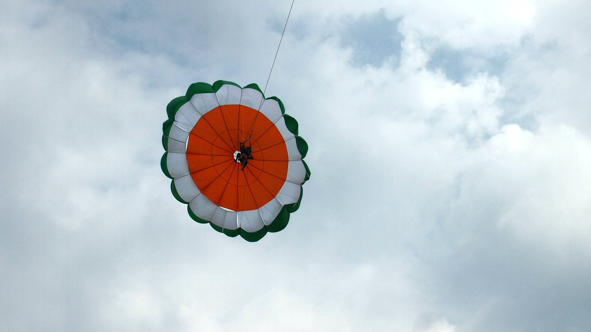 Parasailing Adventure Against Blue Skies Background