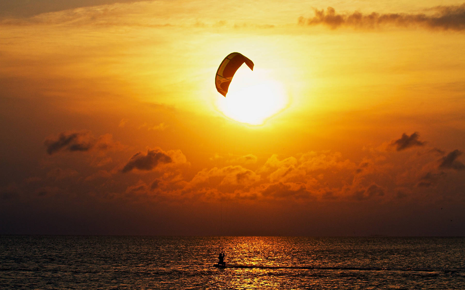 Parasailing With The View Of The Sunset Background