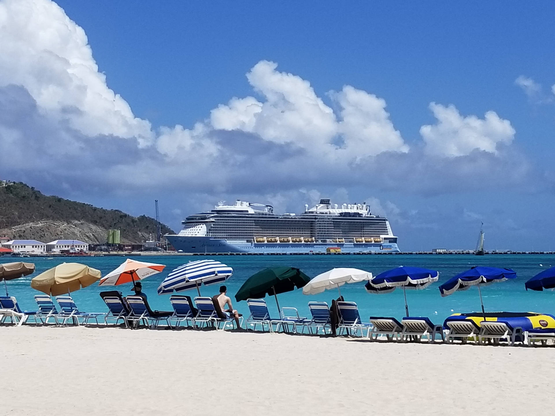 Parasols Lining Up At Sint Maarten Shore Background