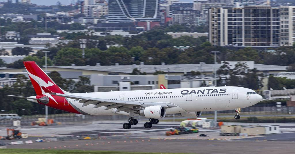 Passenger Aircraft Of Qantas On A Take Off Background