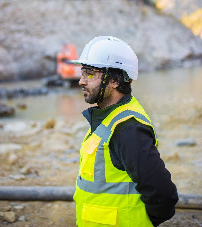 Passionate Engineer At Work In A Construction Site Background