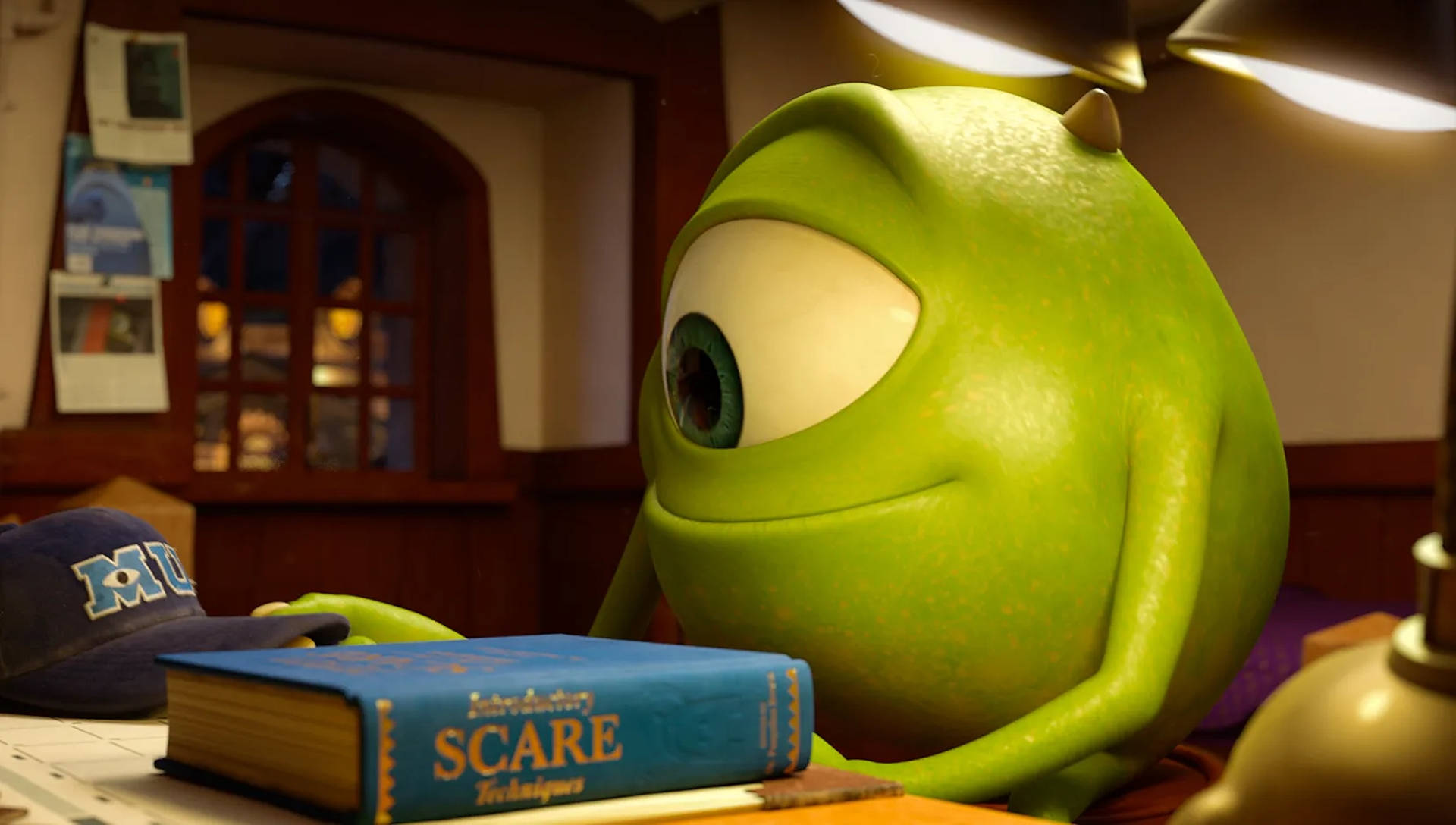 Passionate Mike Studying Hard At Monsters University Background