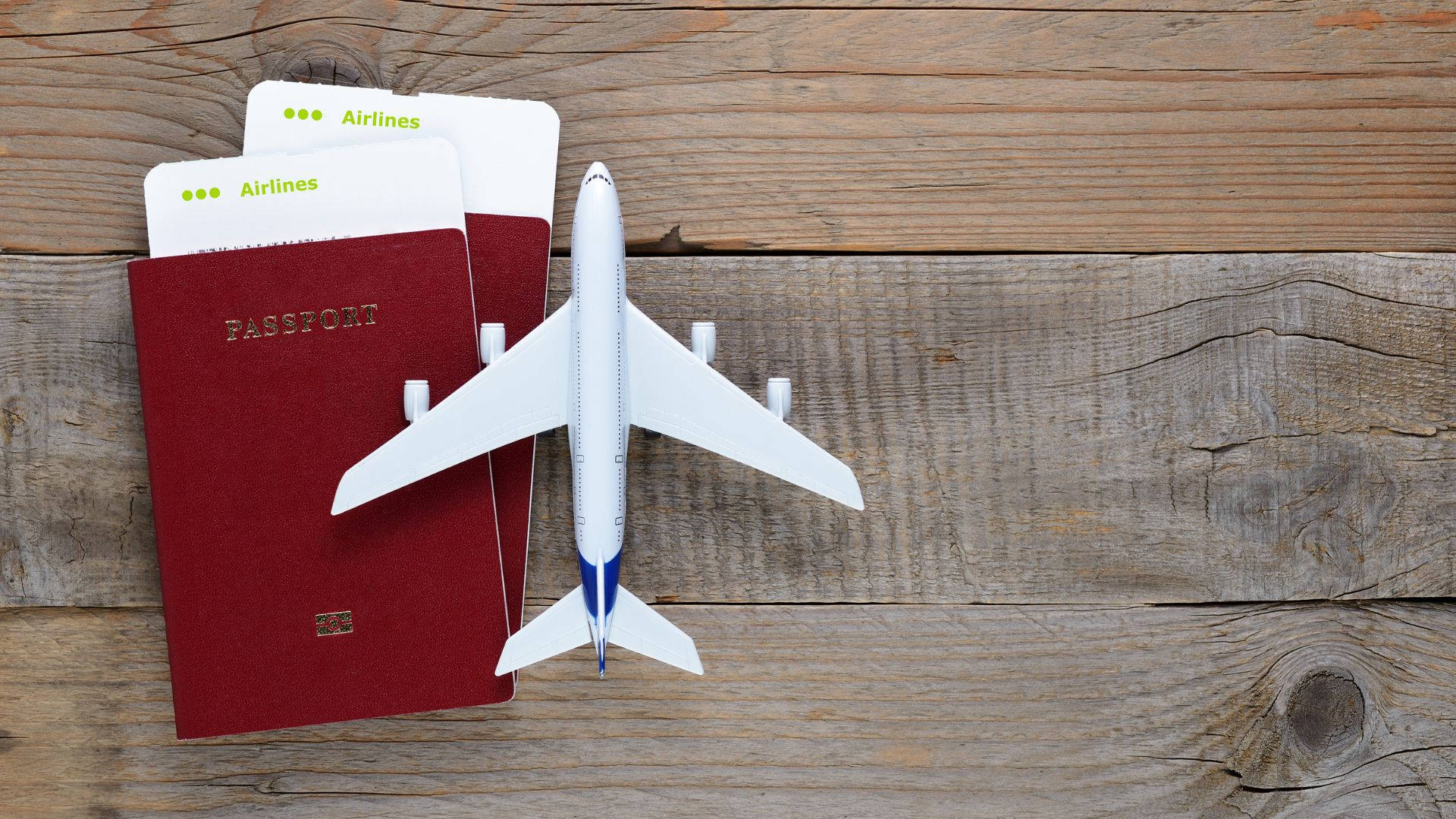 Passport And Airplane Toy On Table