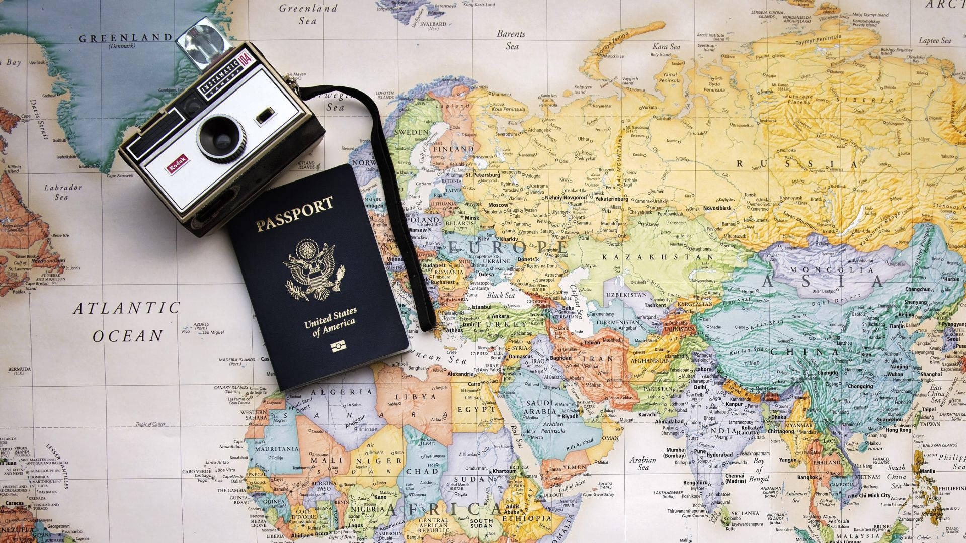 Passport And Camera On World Map Background