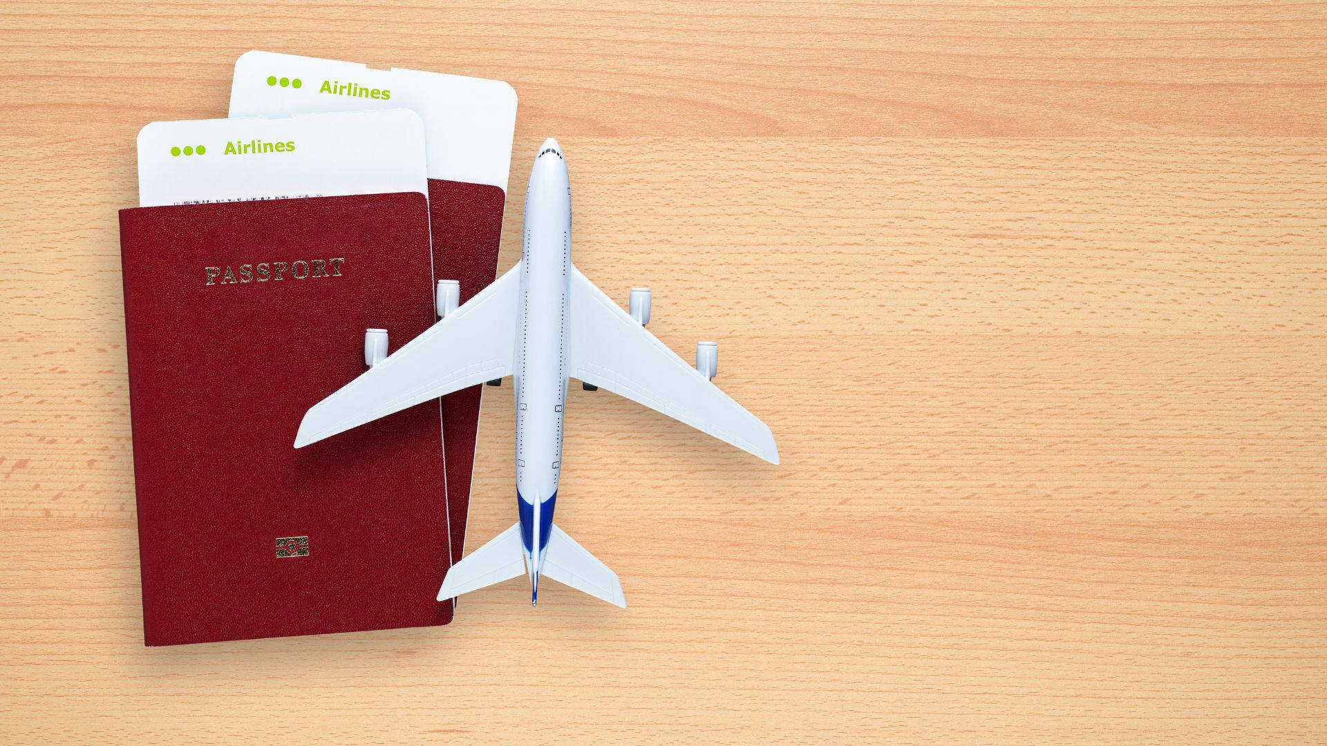 Passport And Toy Airplane On Table Background