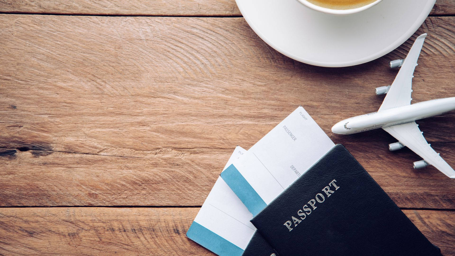 Passport And Toy Airplane On Table Background