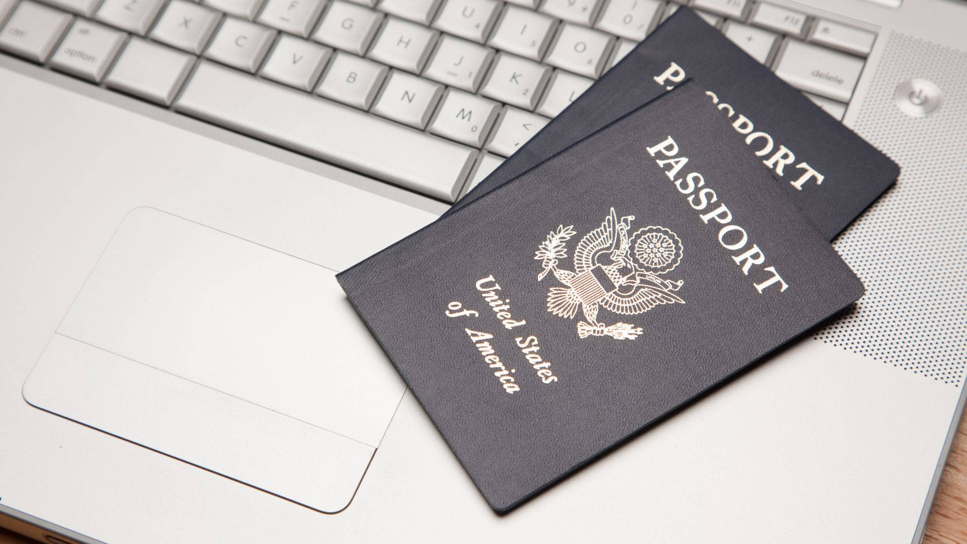 Passport On Silver Laptop Background