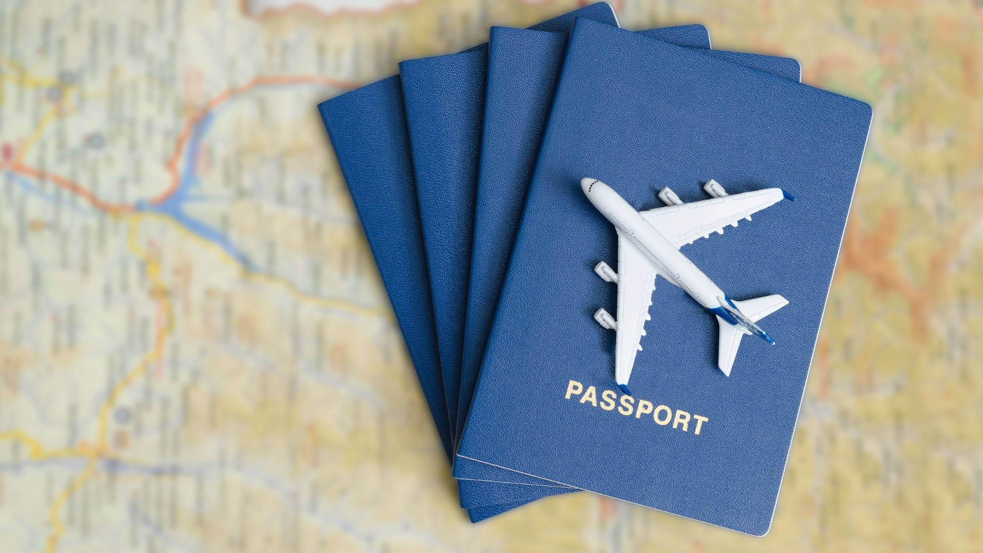 Passport With Toy Airplane On Top Background