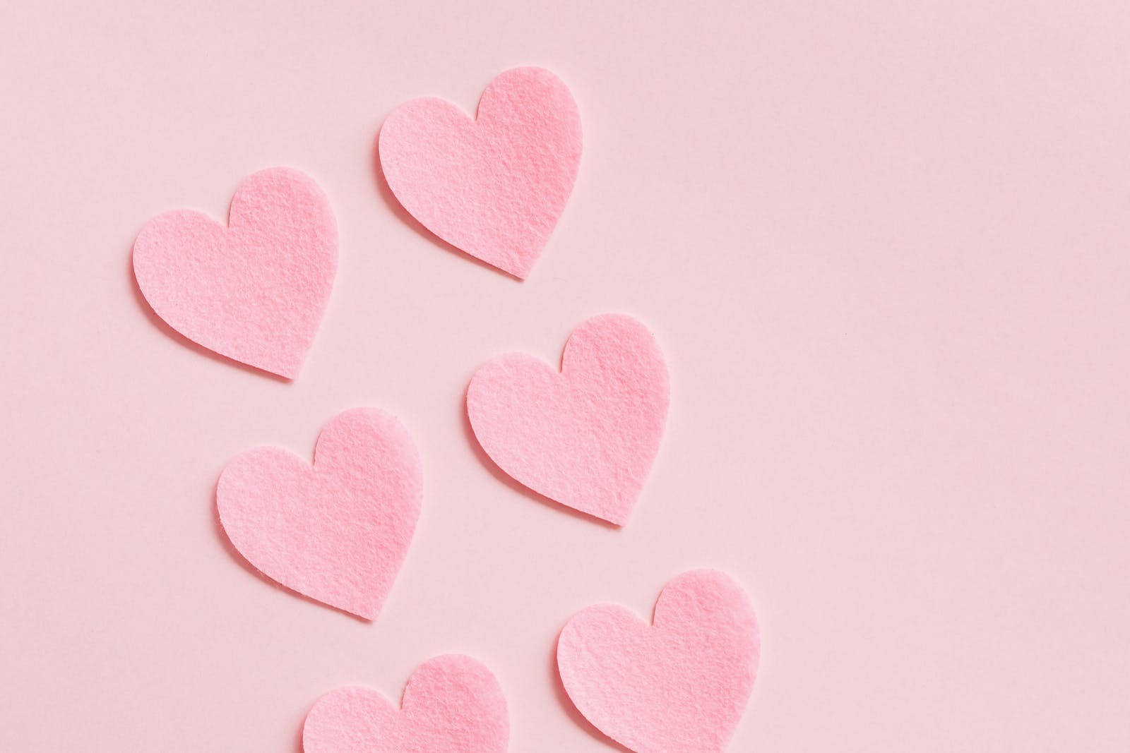 Pastel Pink Heart Cutouts In Pairs Background